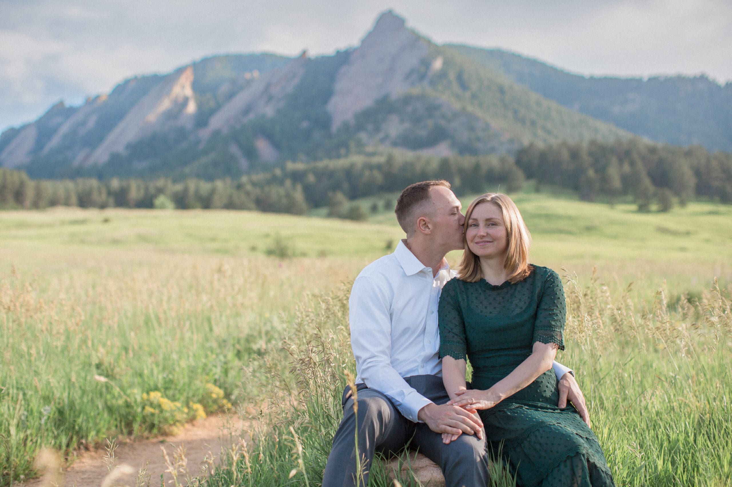 An engaged man kisses his fiance at Chautaqua Park in Boulder, Colorado