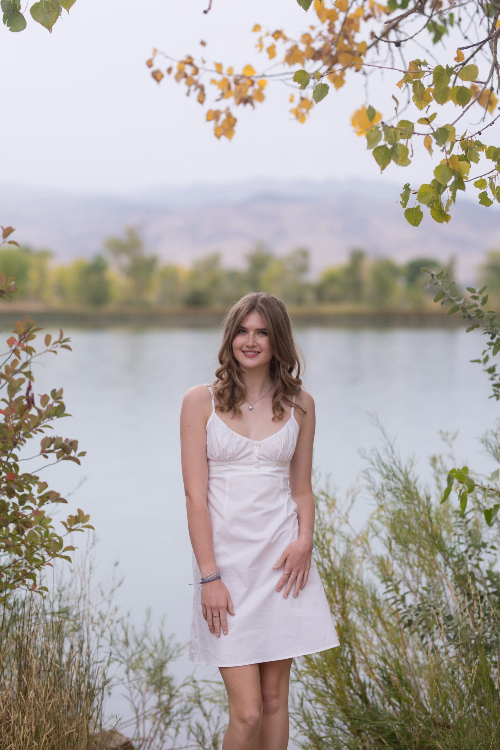 A woman smiles for the camera with Coot Lake in the background