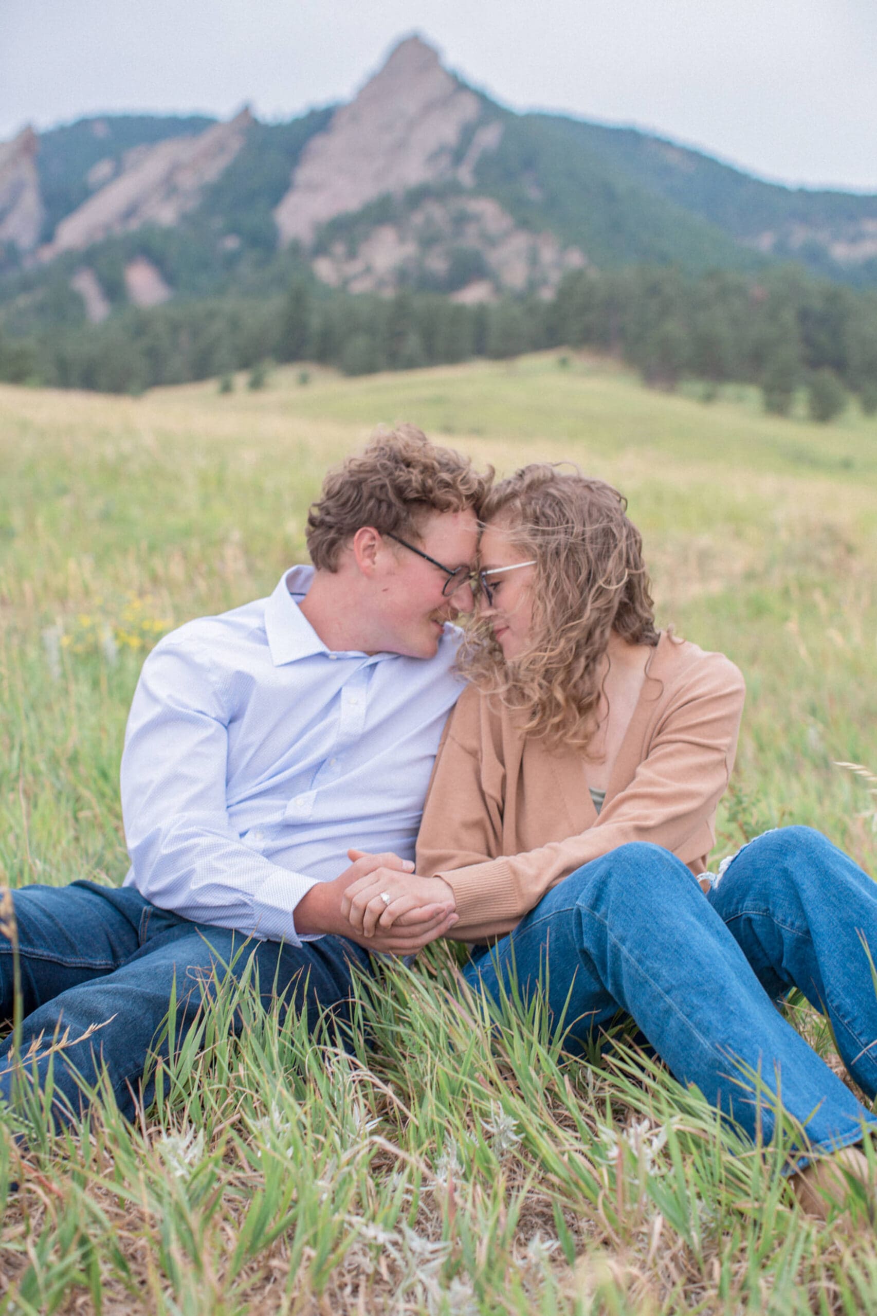 A couple snuggle during their Boulder, Colorado Engagement Photos