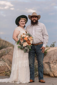 A couple pose for their colorado elopement photographer during their wedding