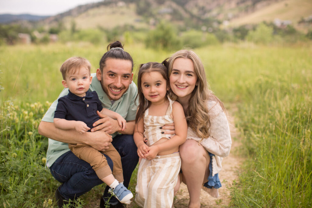 A family of four smiles for the camera at Wonderland Lake in Boulder, Colorado