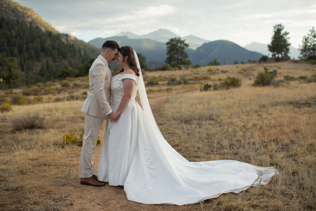 A bride and groom stand close together during their intimate Estes Park Elopement