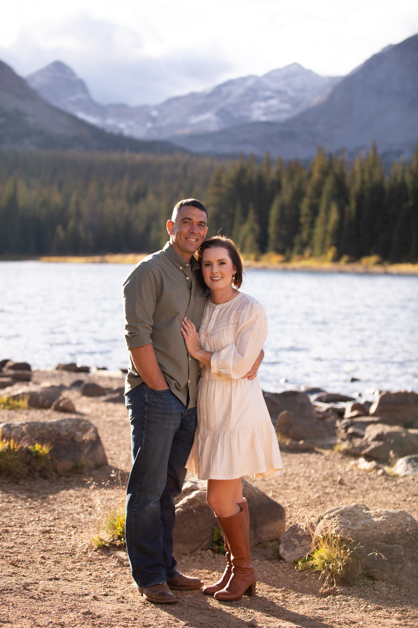 A couple smile for the camera during their engagement photography session at Brainard Lake