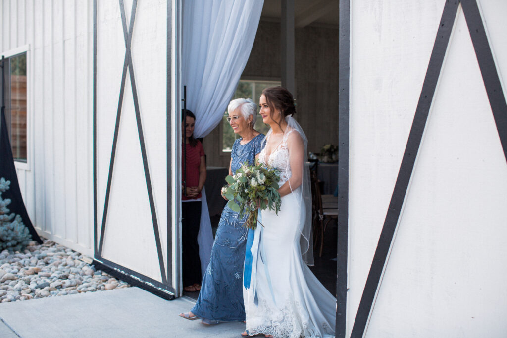 The mother of the bride accompanies her daughter as they enter the wedding ceremony