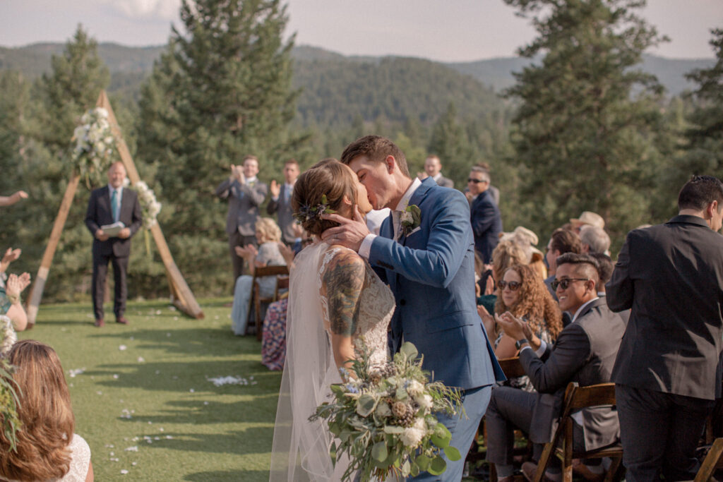 Bride and groom kiss during their grand exit