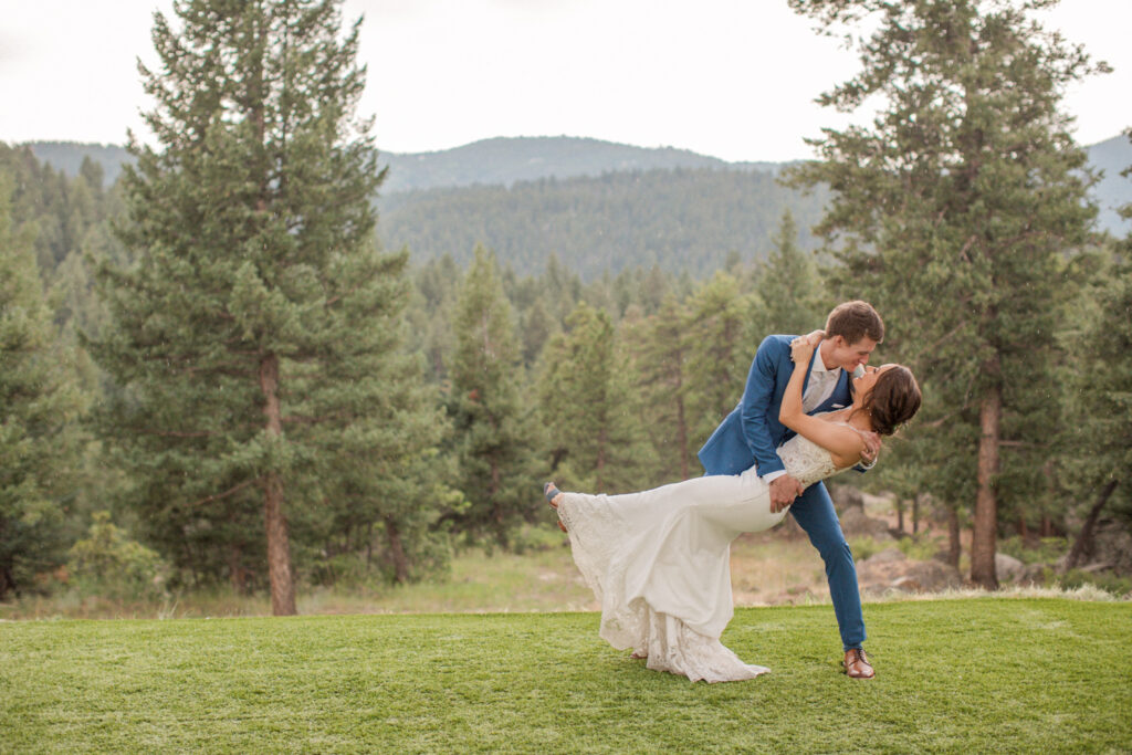 A groom dips his bride during their wedding celebration in Morrison, Colorado. By Stephanie Eddy, Colorado wedding photographer. 