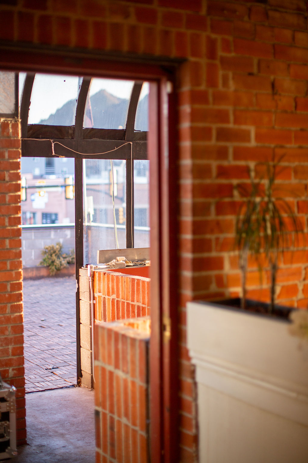 A peek out the back entrance to a 2nd floor balcony patio