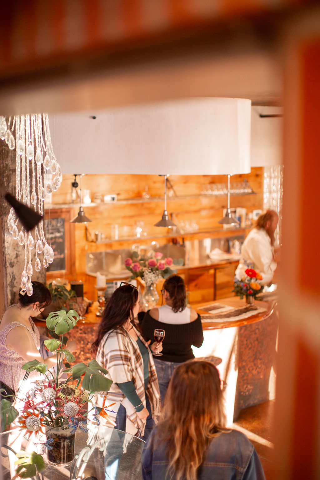 A look down at guests mingling with drinks around the bar