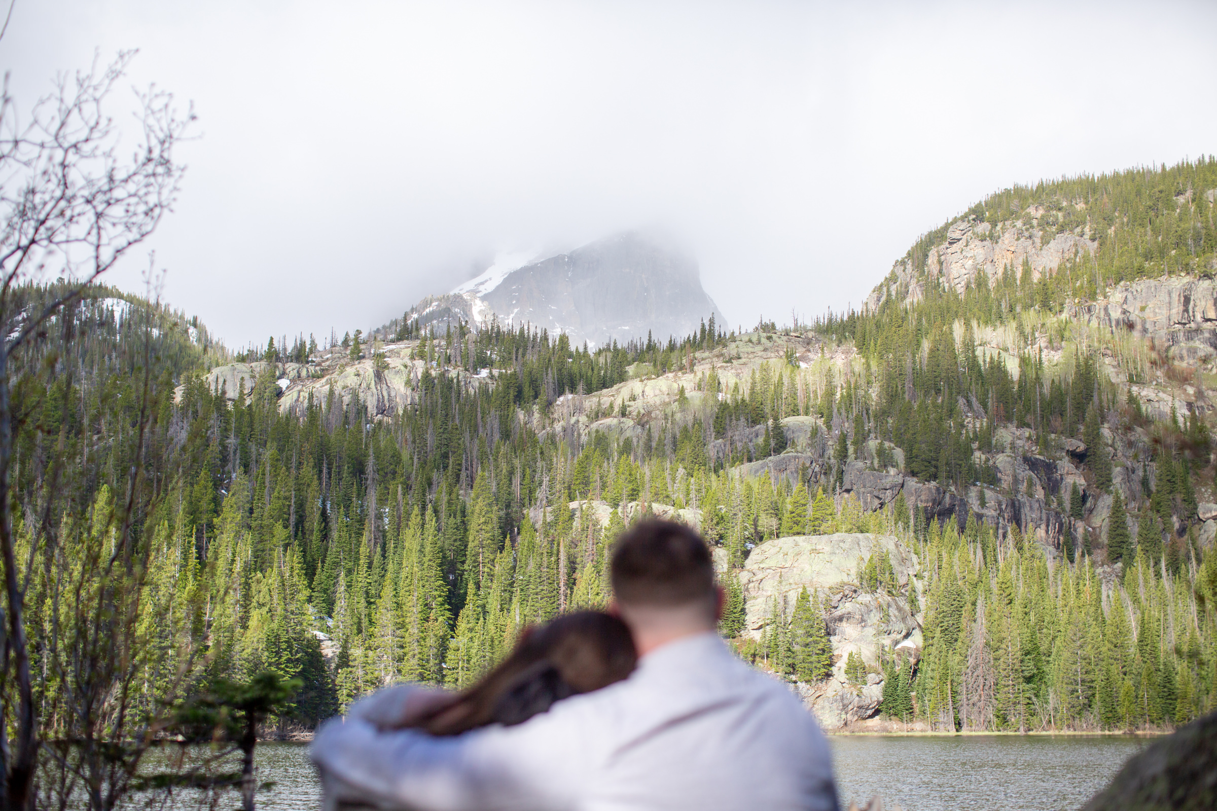 A couple looking at the mountains during their engagement session at Bear Lake