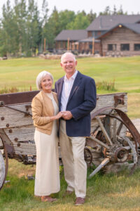 Couple celebrating their 45th anniversary in front of the Keystone Ranch lodge during a Colorado wedding celebration