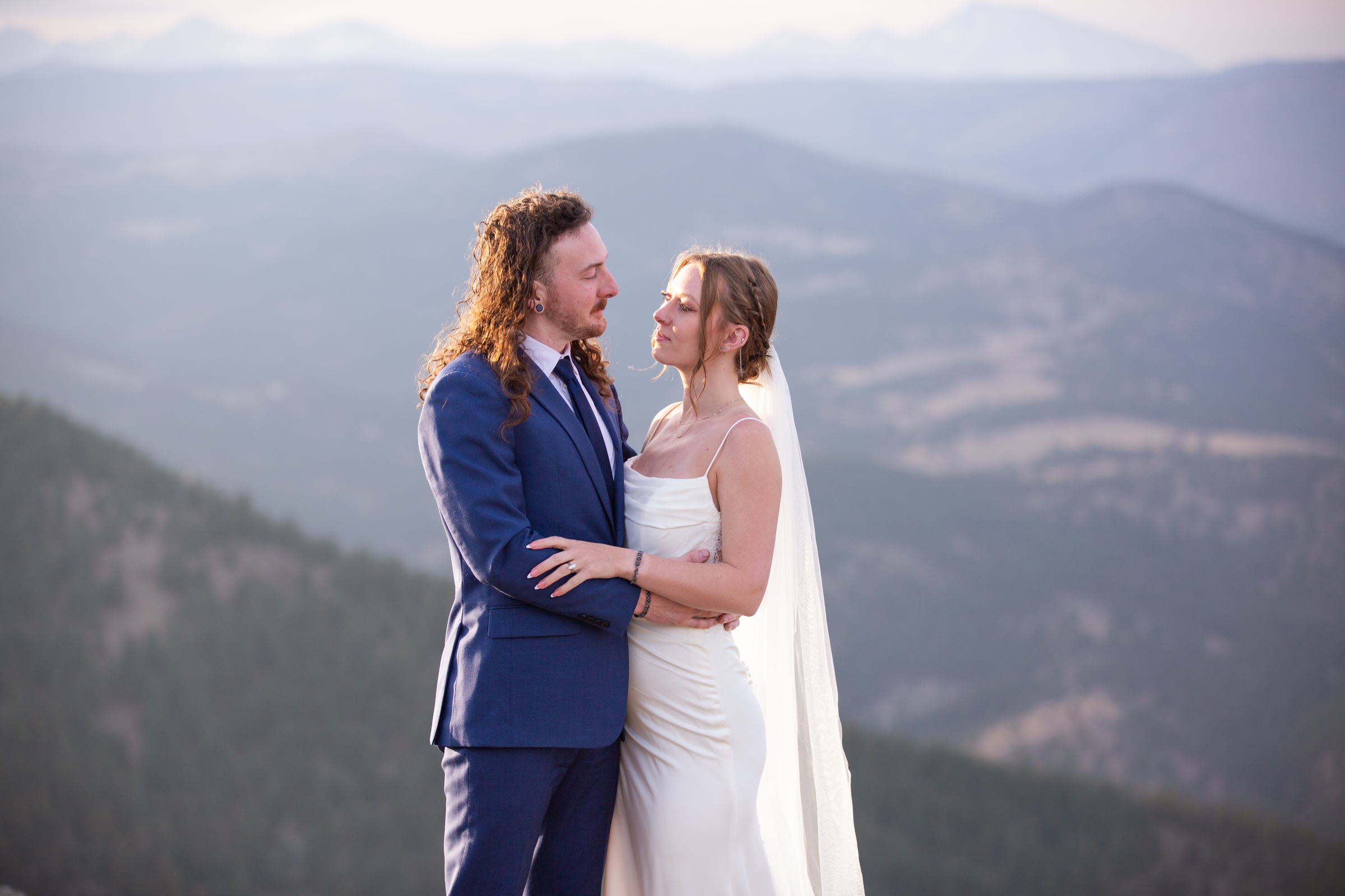 Newlywed eloping couple embracing in the scenic mountains of Rocky Mountain National Park, photographed by a Rocky Mountain National Park elopement photographer.